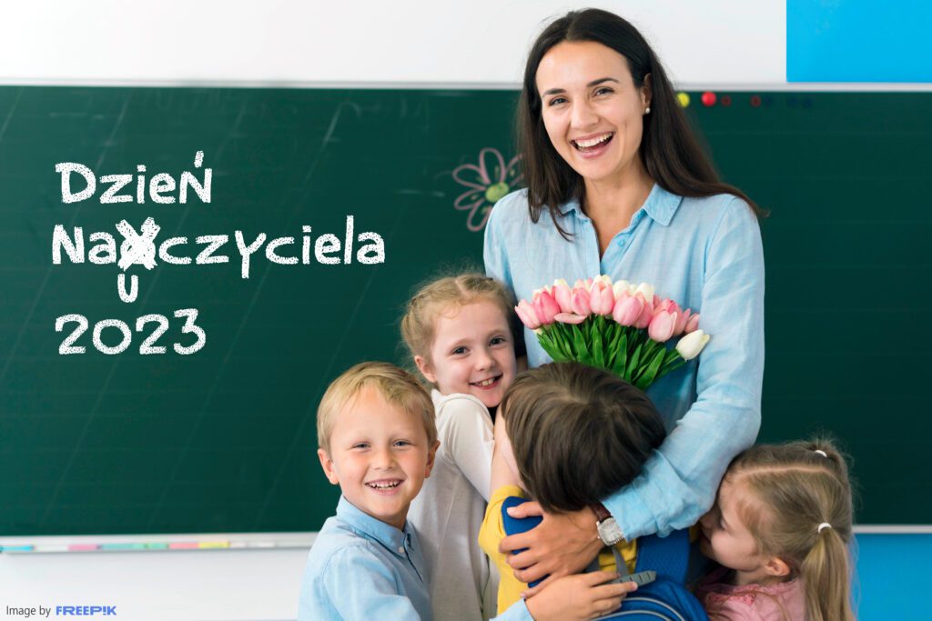 Nauczycielka otoczona przez dzieci, tablica z poprawionym napisem