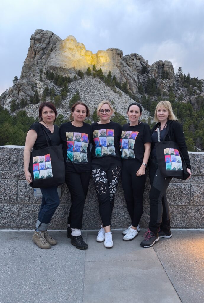 Nauczyciele I LO pozują przy Mount Rushmore.